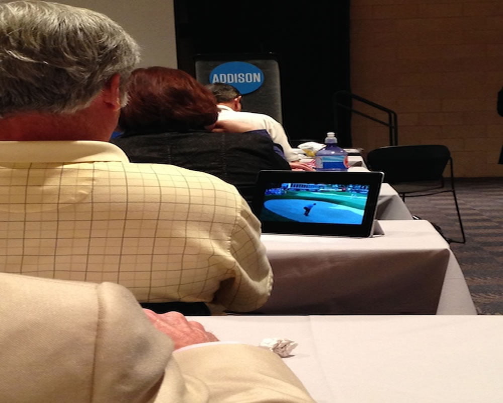 Someone watches golf during the keynote